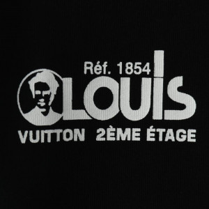LOUIS VUITTON WITH RED AND BLUE LOGO BADGE